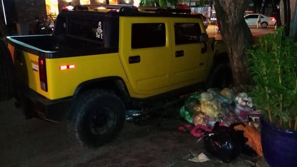 Hummer next to trash